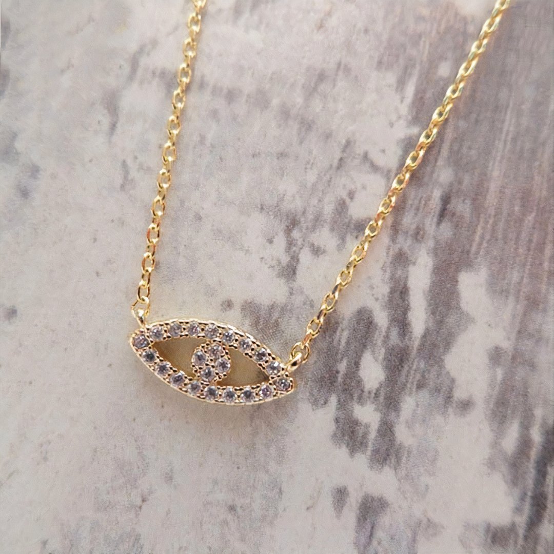 18K gold Abby necklace with delicate chain and pendant, crafted by Whacky Wino, shown on a neutral background.